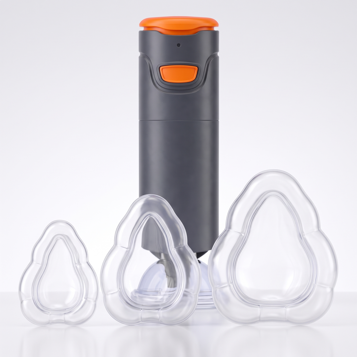 The three clear silicone masks, small, medium and large, beside the device